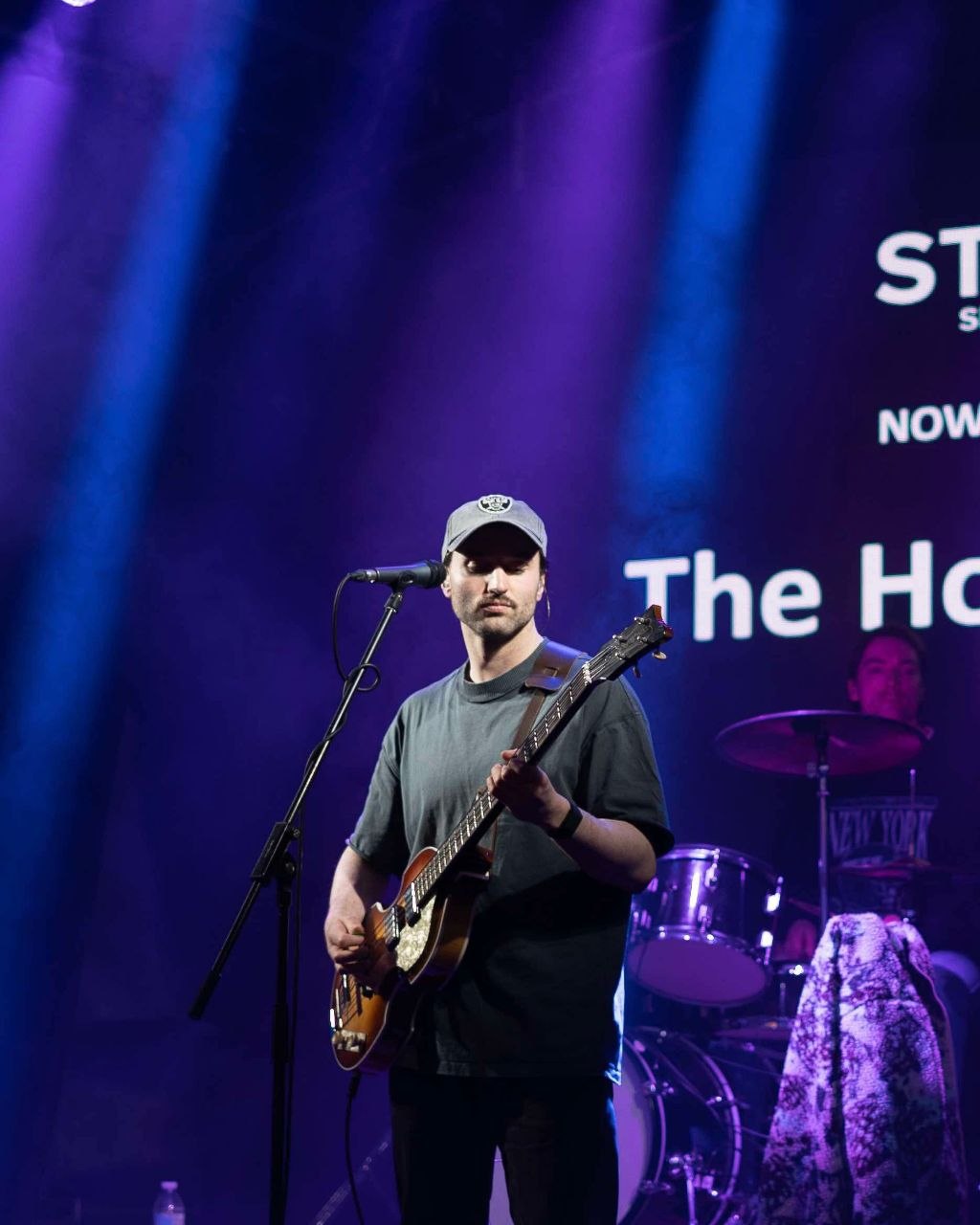 The Houndcats bass guitarist performing on stage